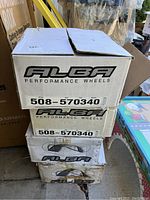 Photo showing four stacked Alba Performance Wheels in their original boxes with style number label.