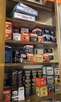 Full cabinet stocked with new oil and air filter boxes organized on shelves.