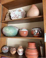 Top shelf with shell-shaped vessel and blush organic-form vase