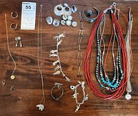 Overview of all jewelry pieces laid out on wooden surface