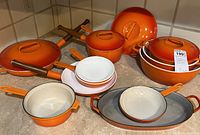 Overview of set on countertop showing all pots, pans, lids, and bowls