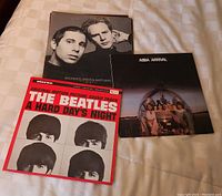 Three visible LP covers: Simon & Garfunkel 'Bookends', ABBA 'Arrival', The Beatles 'A Hard Day's Night' soundtrack.