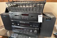 Yamaha stereo receiver, cassette deck, and pair of KEF Q10 speakers with remote and top basket.