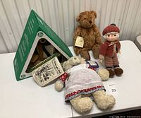 Full lot showing Hermann-Spielwaren mohair bear in original green box, Bowley Bears plush bear, crochet doll, and Blue Mountain Arts bear pin.