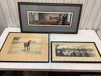 Three framed prints laid flat on table, showing all pieces