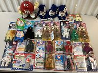 Overview of lot showing all items including M&M dispenser, blue bears, and rows of packaged Ty Beanie Babies