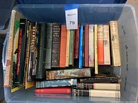 View of boxed collection of approximately 30 assorted books with varied titles visible including a Disney book, horse stories, and adventure themes.