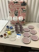 Full set displayed on table including Wedgwood cups, saucers, milk and sugar containers, glasses, shakers, ashtrays, Limoges tea set, and decorative box