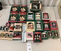Full view of the Hallmark Keepsake Holiday Ornaments collection showing various boxed ornaments including dollhouse miniature houses, Santa Maria, thimble bells, mouse collection, and Santa figurines.