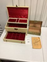 Large yellow beige leather antique jewelry box with red velvet lining, multiple compartments inside drawer, with key
