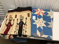 Both folded textiles displayed side by side on table