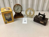 Overall view of all four items: mini globe box, wooden clock, acrylic clock and sewing machine music box