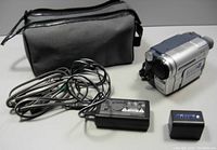 Sony Handycam with cords, carrying bag, and battery shown