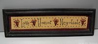Front view of the framed cottage art sign displaying 'Love Honor Negotiate' with floral designs in a dark frame.
