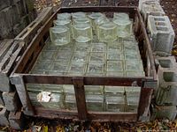 Wooden crate packed with clear square glass blocks arranged in a grid