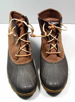 Front view of Sperry waterproof duck boots showing brown leather and black rubber design with tan laces.