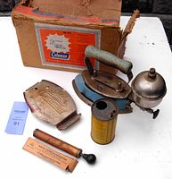 Vintage Coleman No. 4-A iron shown with original box, metal cover, gasoline canister, and Roto-Type Generator tool.