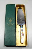 Vintage cake lifter with painted floral bone china handle and stainless steel blade in original green box with gold lining and Staffordshire Crown logo.