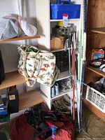 Wide view of shelving with patterned dive bag, dry bag, gloves, and assorted gear