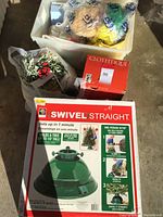 Overview of boxed tree stand, artificial greenery, Clothique box, and wrapped Easter decorations