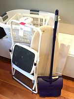 View of step stool, laundry basket, drying rack, and broom together in laundry area