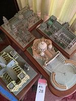 Overview of five cathedral models on wooden bases