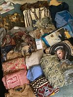 Overview of assorted men's shirts featuring ethnic prints, tropical themes, and solid colors showing the variety in the lot