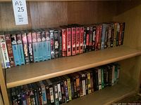 Wide angle view of multiple VHS tapes showcasing various sci-fi and thriller genres including Outer Limits, Starship Troopers, and Planet of the Apes