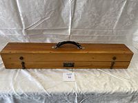 Closed wooden case with handle and metal latches, lot tag 58 visible