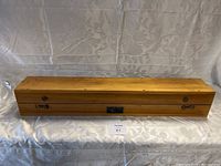 Closed rectangular wooden case with brass hinges and front latches, U.S. Navy Spyglass nameplate on top