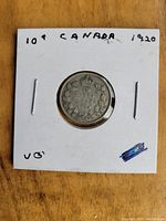 Reverse side of a 1920 Canadian 10 cent coin showing wreath and denomination.