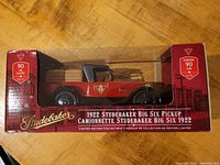 Front view of the boxed 1922 Studebaker Big Six Pickup model in red with clear plastic window showing the model inside.