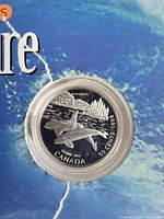 Front side of the 1998 Canadian 50 cent silver coin featuring an orca design with a forest background in proof quality.