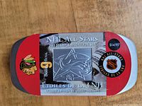 Photo of the 2001 NHL All Stars Stamp and Medallion Set metal tin packaging with NHL and Colorado Avalanche logos and Bobby Hull's name.