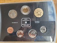 Photo of the set showing all seven coins in black holder with Royal Canadian Mint emblem in center
