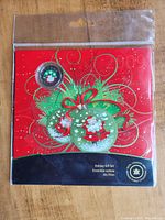 Front of the sealed 2009 Royal Canadian Mint Holiday Gift Set featuring coloured Santa Claus coin and holiday themed backdrop.