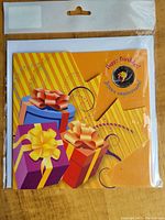 Front of the original sealed package with colorful birthday gift box design and Happy Birthday emblem indicating the coin set.