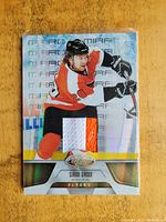 Front of the 2011-2012 Claude Giroux Certified jersey card showing player image, game-used jersey patch with white, orange, and black colors, and Certified logo.