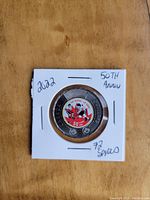 Front side of the coin showing the 50th Anniversary of the 1972 Canada vs Russia Hockey Series logo with hockey players and a maple leaf.