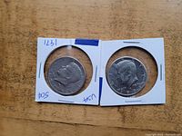 Front view of two 1971 US half dollar coins, showing the profile of JFK.