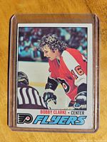 Front of 1977-78 OPC Bobby Clarke Flyers hockey card in protective sleeve.