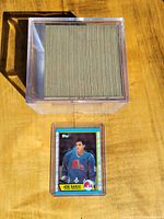 Stack of hockey cards inside a clear plastic case with Joe Sakic rookie card in front.