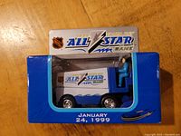 Front view of boxed die cast Zamboni featuring 1999 Tampa Bay NHL All Star Game branding and date January 24, 1999.