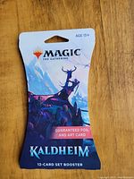 Unopened Magic The Gathering Kaldheim 12-card booster pack with guaranteed foil and art card.