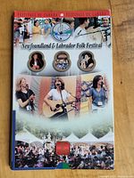 Cardboard backing featuring images and branding for the Newfoundland and Labrador Folk Festival, part of the Festivals of Canada series.