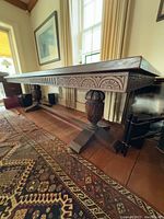 Angled view showing carved apron and pedestal base