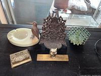 Overview photo showing all six items on display including the letter holder, two ashtrays, ruler, pen holder, and hinged box.