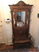 Front view of entire hall tree showing bench, mirror and coat hooks
