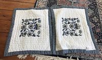 Two baby quilts laid side by side showing overall size and pattern.