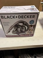 Boxed Black & Decker cordless lithium hand vacuum with image and brand details visible on box.